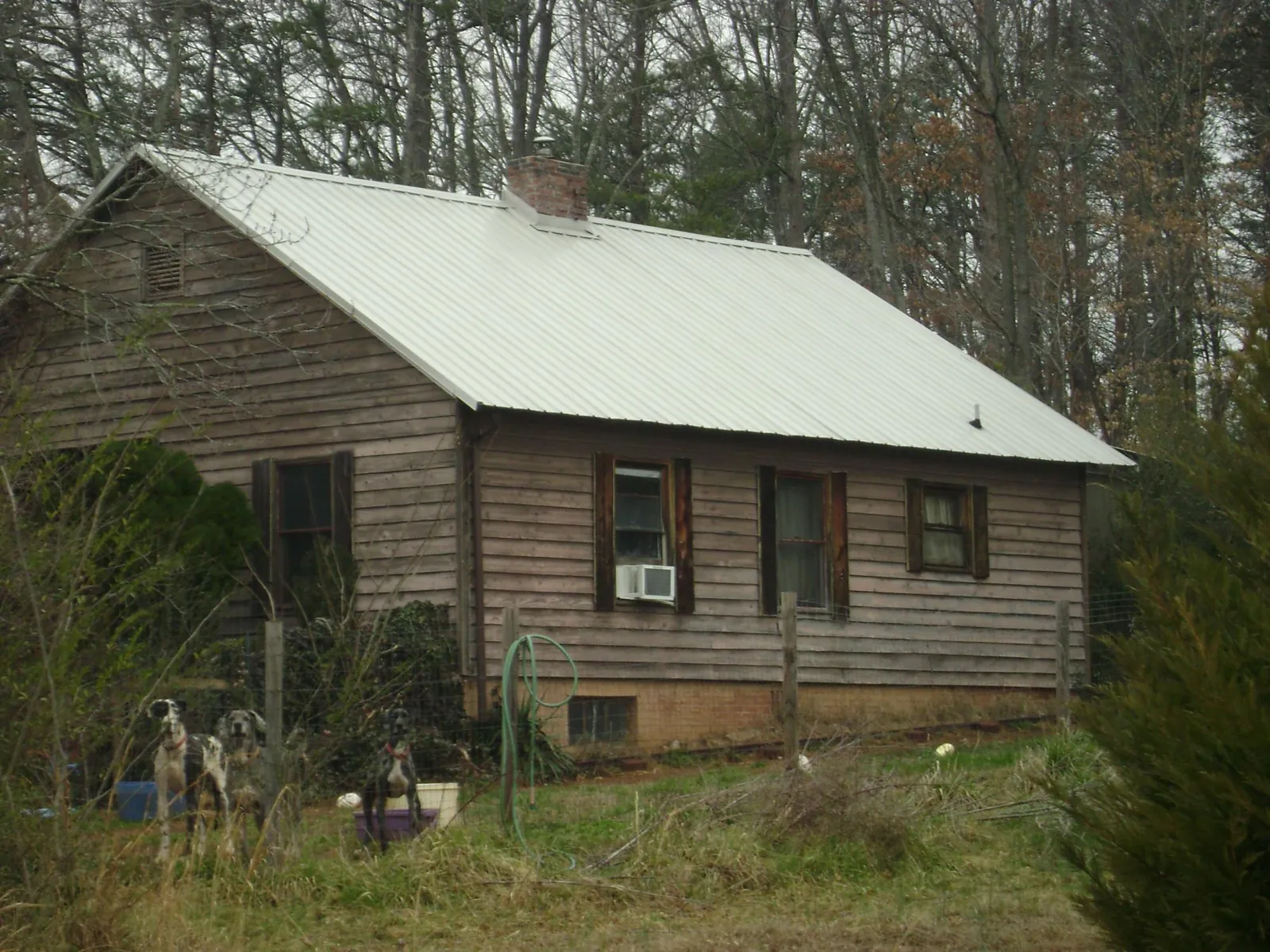 White metal roof on an old wood sided farmhouse, from a Metal Roof Installation job in Quakertown